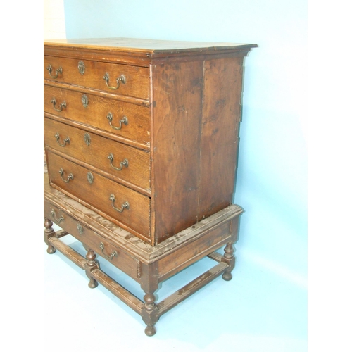 53 - An 18th century oak chest of four drawers on stand, with one drawer, on turned legs, 97cm wide, 123c... 