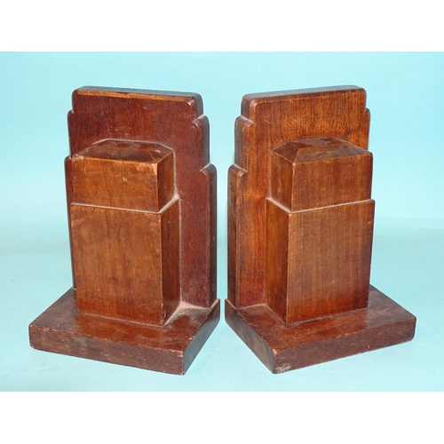 64 - A pair of Gordon Russell Ltd walnut bookends, 17cm high, 12cm wide, stamped Gordon Russell Ltd and a... 