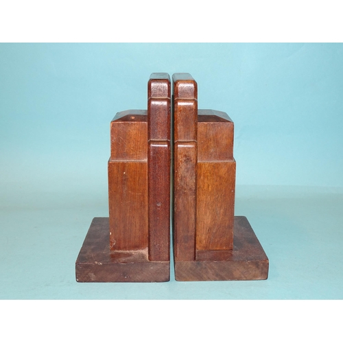 64 - A pair of Gordon Russell Ltd walnut bookends, 17cm high, 12cm wide, stamped Gordon Russell Ltd and a... 