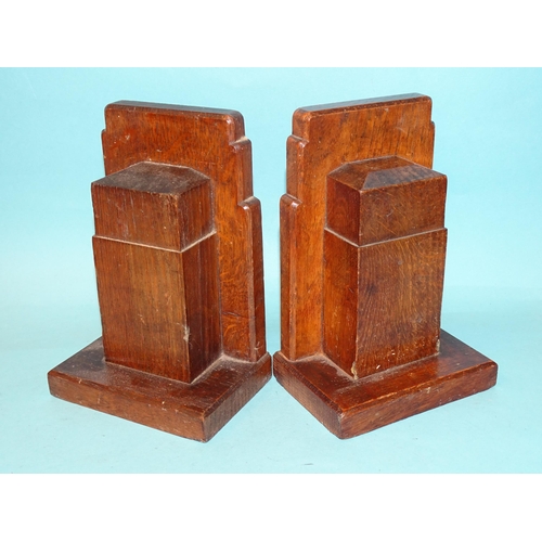 64 - A pair of Gordon Russell Ltd walnut bookends, 17cm high, 12cm wide, stamped Gordon Russell Ltd and a... 