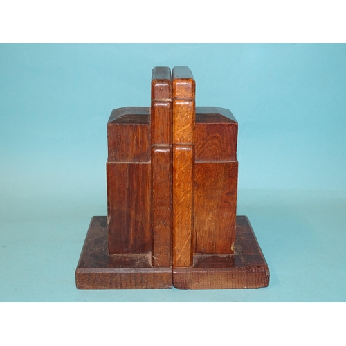 64 - A pair of Gordon Russell Ltd walnut bookends, 17cm high, 12cm wide, stamped Gordon Russell Ltd and a... 