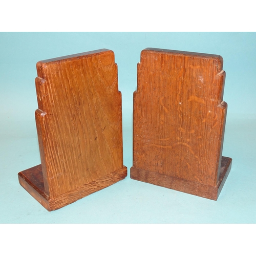 64 - A pair of Gordon Russell Ltd walnut bookends, 17cm high, 12cm wide, stamped Gordon Russell Ltd and a... 