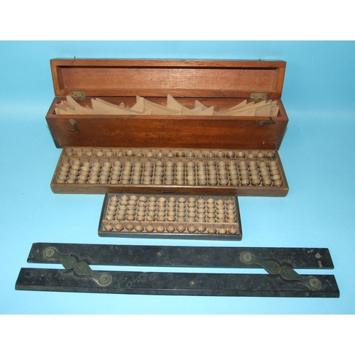 74 - A Chinese turned wood abacus, with Chinese script beneath, 19 x 7cm, a larger abacus, 35 x 8.5cm and... 