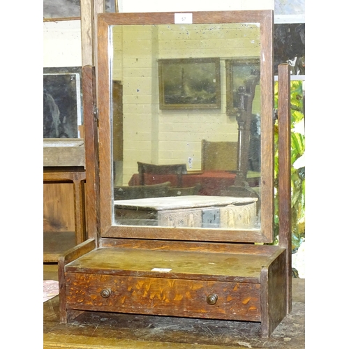 57 - An oak dressing table mirror in the style of Heal & Son, with plain rectangular plate and single... 