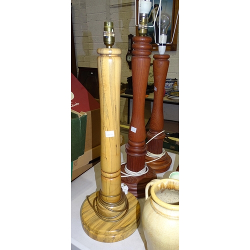 142 - A collection of nine craftsman-made turned wood table lamps, tallest 63cm.