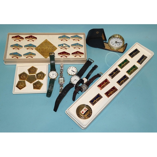 221 - A collection of modern naval ship and space badges and six various wrist watches.