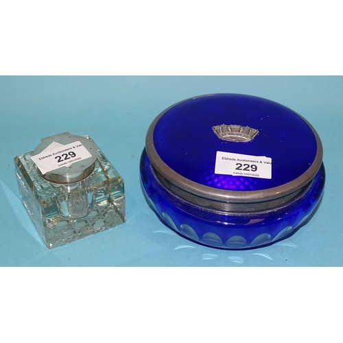 229 - A blue and clear glass dressing table jar with silver and blue enamelled cover and central applied c... 