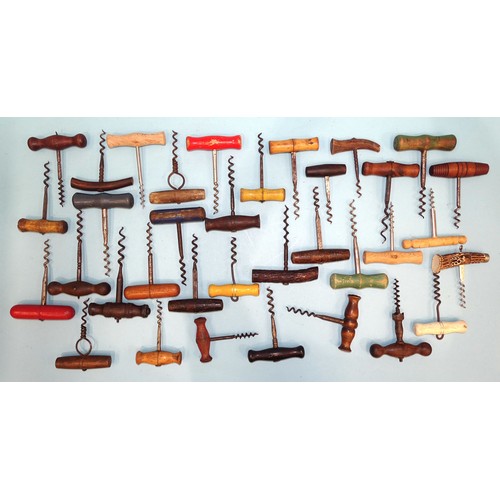 199 - A large collection of wood-handled corkscrews.