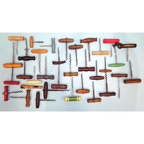 199 - A large collection of wood-handled corkscrews.