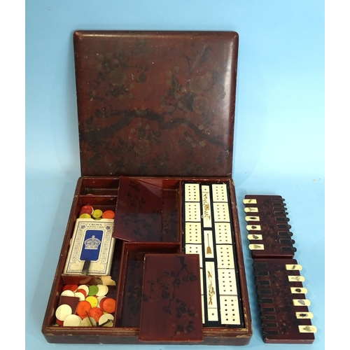 157 - A Japanese lacquer games compendium, the square box and cover with flowering branch decoration on a ... 