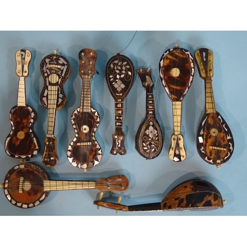 159 - A collection of nine late-19th century tortoiseshell and mother-of-pearl miniature musical instrumen... 