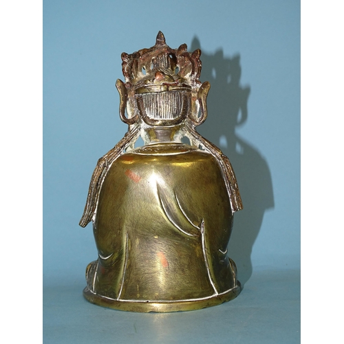 162 - A brass figure of a seated Buddha holding a cup in their left hand, 17cm high.