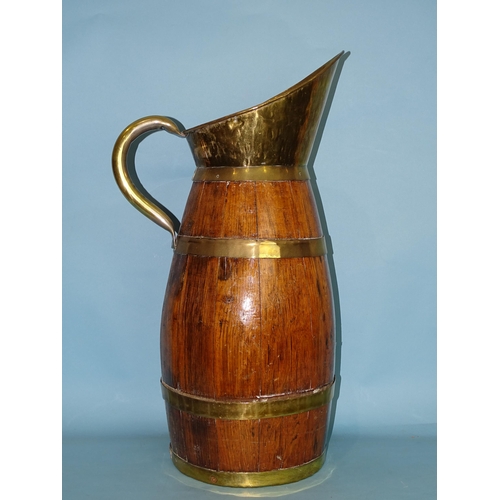 164 - A late-19th/early-20th century oak and brass coopered barrel-shaped jug of large proportions, with b... 