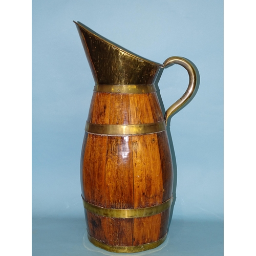 164 - A late-19th/early-20th century oak and brass coopered barrel-shaped jug of large proportions, with b... 