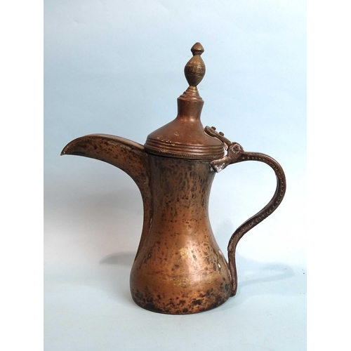 171 - A Middle Eastern copper coffee pot, 33cm high, (purchased in Yemen).