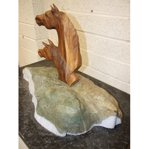 72 - Bridget Dumper MA (Sculpture) SWA, a carved wood sculpture of two horses' heads on naturalistic ston... 