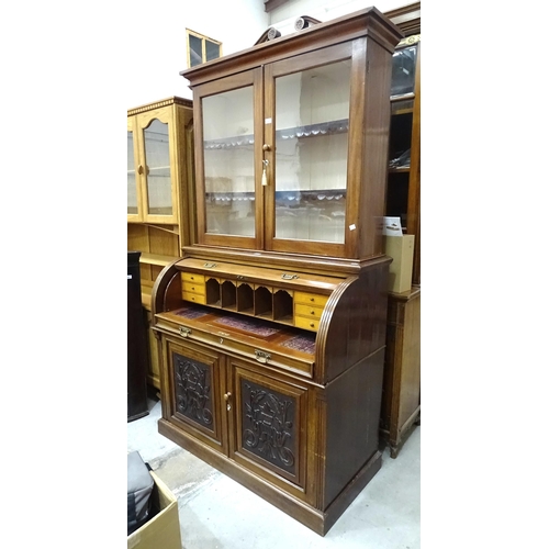 86 - A 19th century mahogany cylinder desk, the fitted desk with pull-out writing surface, above a pair o... 