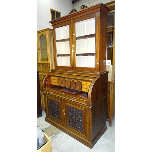 86 - A 19th century mahogany cylinder desk, the fitted desk with pull-out writing surface, above a pair o... 