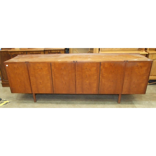 93 - A 1960's teak sideboard, possibly Robert Heritage, the rectangular top above six doors, with interna... 