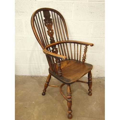 97 - A 19th century yew wood and elm-seated Windsor armchair with crinoline stretcher and turned legs.... 