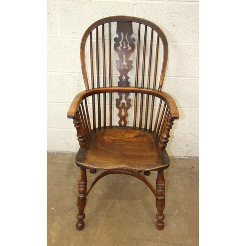 97 - A 19th century yew wood and elm-seated Windsor armchair with crinoline stretcher and turned legs.... 