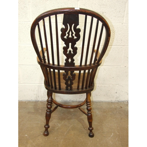 97 - A 19th century yew wood and elm-seated Windsor armchair with crinoline stretcher and turned legs.... 