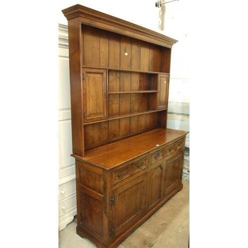 99 - A Georgian oak dresser, the plate rack fitted with two small cupboards above three drawers and two p... 