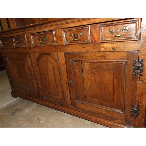 99 - A Georgian oak dresser, the plate rack fitted with two small cupboards above three drawers and two p... 