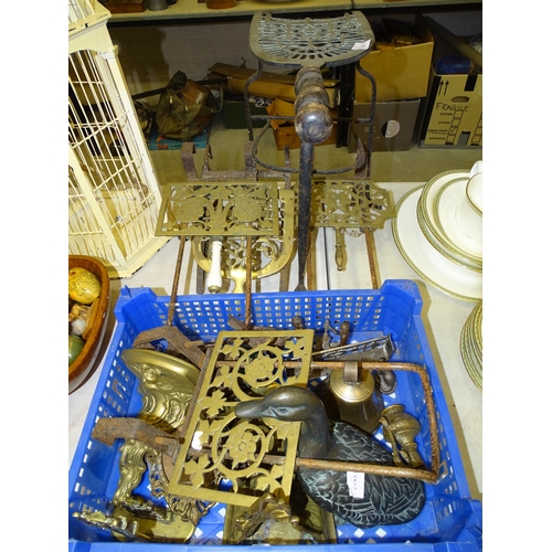 106 - Five brass and iron trivets, a brass bell and other brass and metalware.