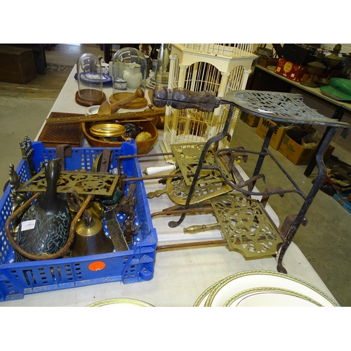 106 - Five brass and iron trivets, a brass bell and other brass and metalware.