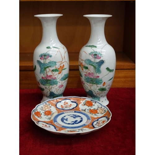 169 - An Imari decorated plate, 21cm diameter and a pair of 20th century Japanese vases with floral decora... 