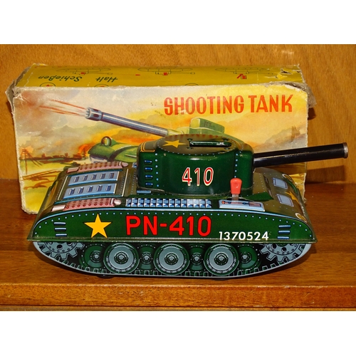 174 - A vintage West German made tin-plate c/w tank, firing wooden shells, 24cm long in original box (end ... 