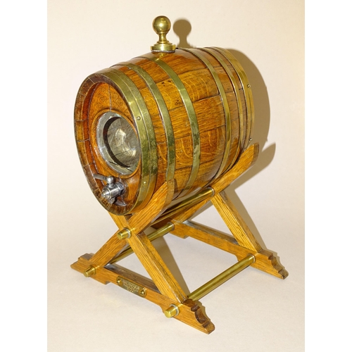 177 - An oak and brass coopered cask with glass end panels, inscribed Made from a piece of one of the... 