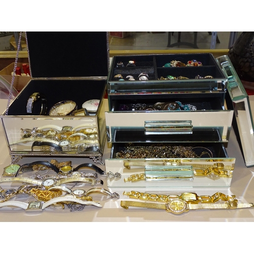 210 - A quantity of costume jewellery and wrist watches in two mirrored jewellery boxes.