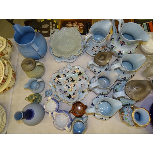 89 - A collection of 19th century ironstone style floral decorated jugs,  on a blue ground, tallest 24cm,... 