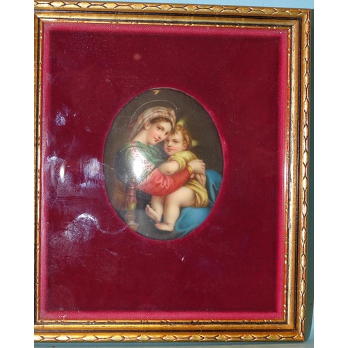 125 - A Continental oval ceramic plaque depicting the Madonna & Child, 8.2 x 6cm, framed.... 