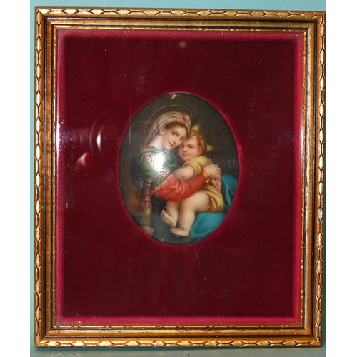 125 - A Continental oval ceramic plaque depicting the Madonna & Child, 8.2 x 6cm, framed.... 