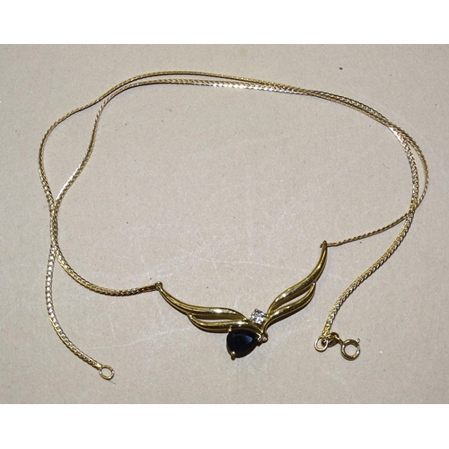 137 - A 9ct gold necklet with pendeloque sapphire below a diamond point, 42.5cm long, 3.6g.... 