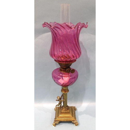 78 - A Victorian brass column oil lamp, the column with winged cherub on square base and scroll feet, wit... 