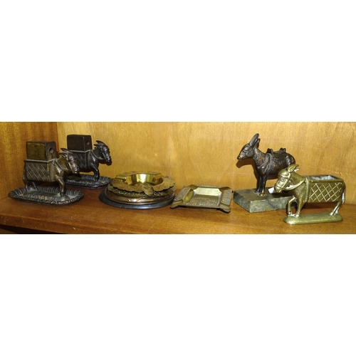 82 - Two 'Bryant & May' cast iron advertising match holders in the form of donkeys, 10.5cm high, a si... 