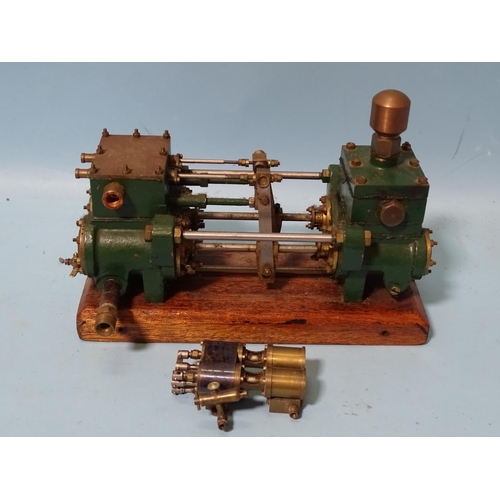 432 - An unmarked twin-cylinder horizontal steam engine and a small brass engine part, (2).... 