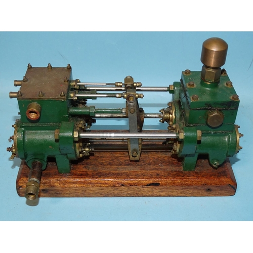 432 - An unmarked twin-cylinder horizontal steam engine and a small brass engine part, (2).... 