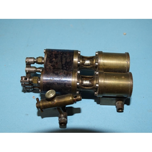 432 - An unmarked twin-cylinder horizontal steam engine and a small brass engine part, (2).... 