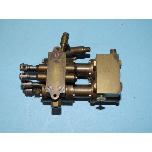 432 - An unmarked twin-cylinder horizontal steam engine and a small brass engine part, (2).... 