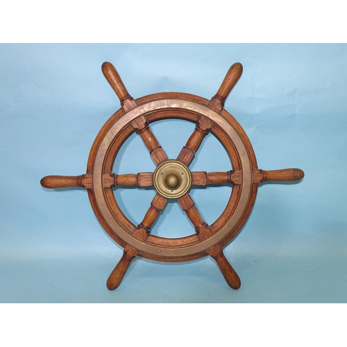 460 - A teak six-spoke ship's wheel with brass central boss and circular fittings, 51.5cm diameter, includ... 