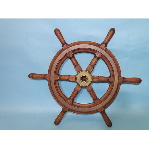 460 - A teak six-spoke ship's wheel with brass central boss and circular fittings, 51.5cm diameter, includ... 