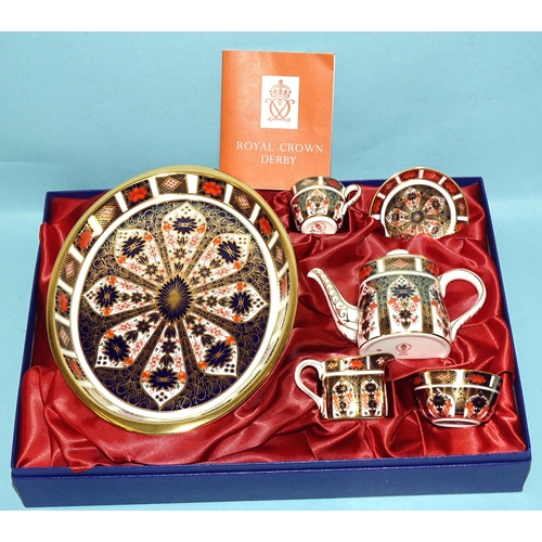 A Royal Crown Derby Imari miniature tea set, comprising oval tray, teapot, cup, saucer, milk jug and sugar bowl, all pattern 1128, (boxed).