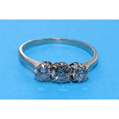 421 - A three-stone diamond ring claw-set old brilliant-cut diamonds, in unmarked white metal ring, (tests... 