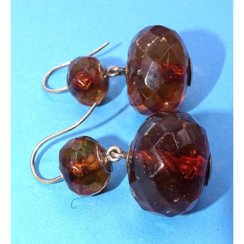 423 - A pair of Victorian amber drop earrings, each set two faceted amber beads, on gold fittings, 35mm lo... 