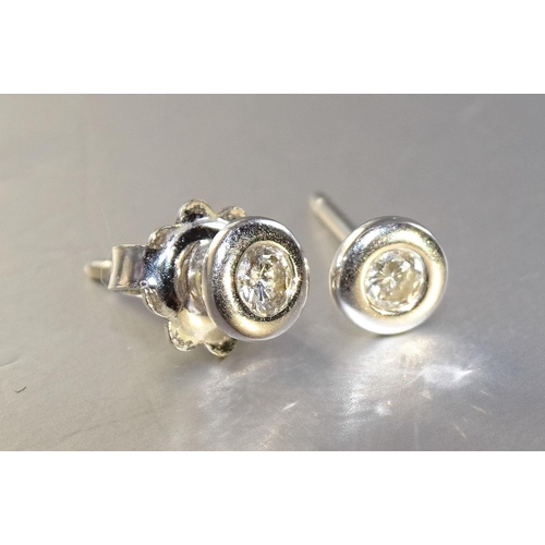 448 - A pair of diamond and platinum ear-studs, each collet set a brilliant cut diamond of approximately 0... 